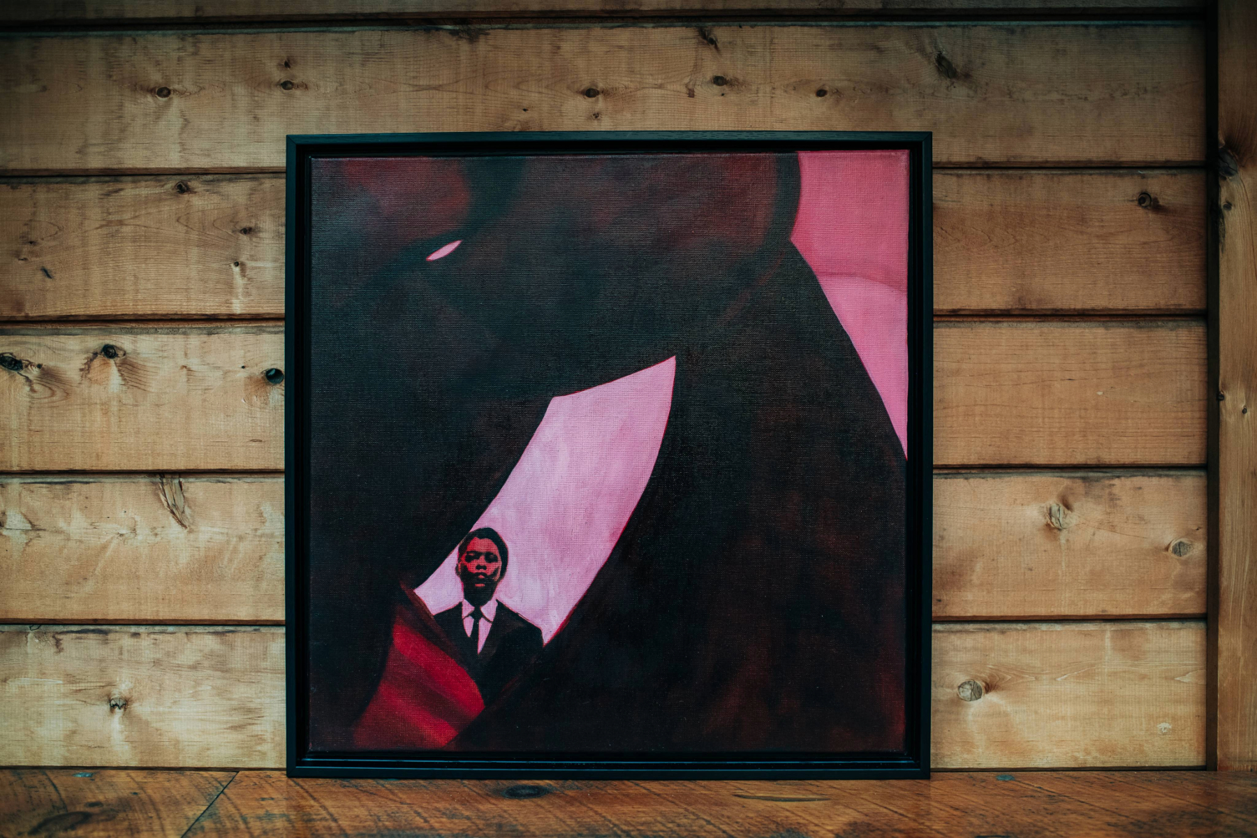 Oil portrait of Andrew Hill in pink and red